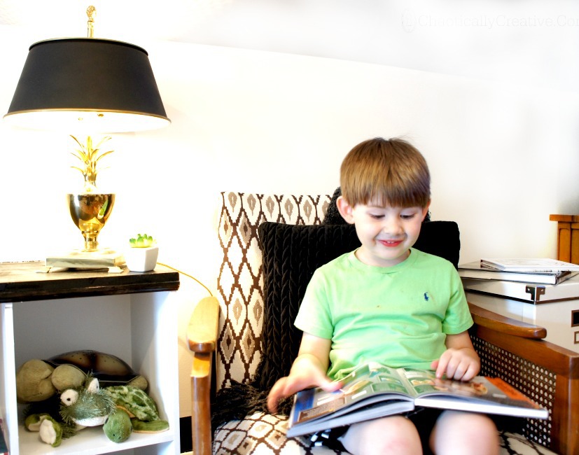 Child Reading Book on Vintage Chair